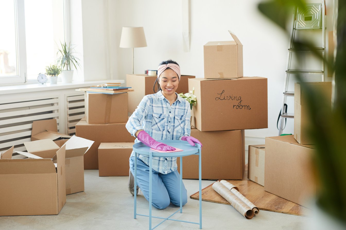 Happy Asian Woman Cleaning New House after Moving